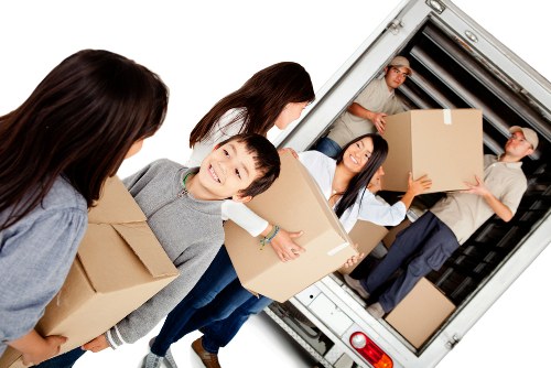 Same-day removals team handling boxes and furniture in Bow