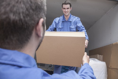 Moving team planning a local removal in Bow with boxes and furniture
