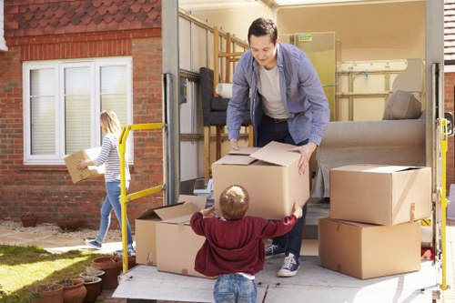 Loading boxes and household items into a van in Bow