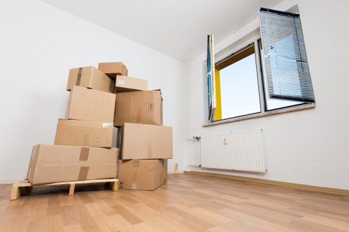 Residents preparing belongings for a flat move in Bow with labels and packing supplies